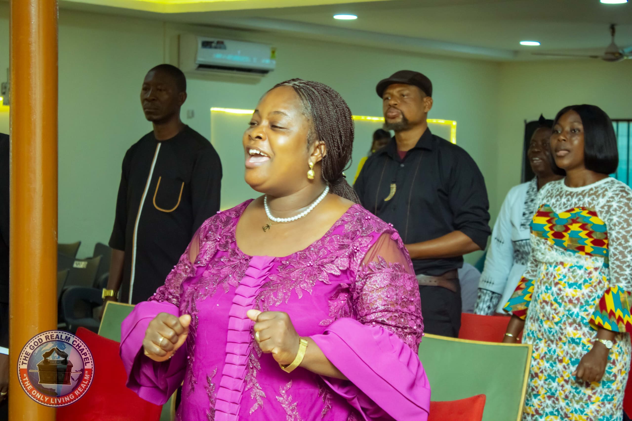 Congregation worshipping and singing at The God Realm Chapel