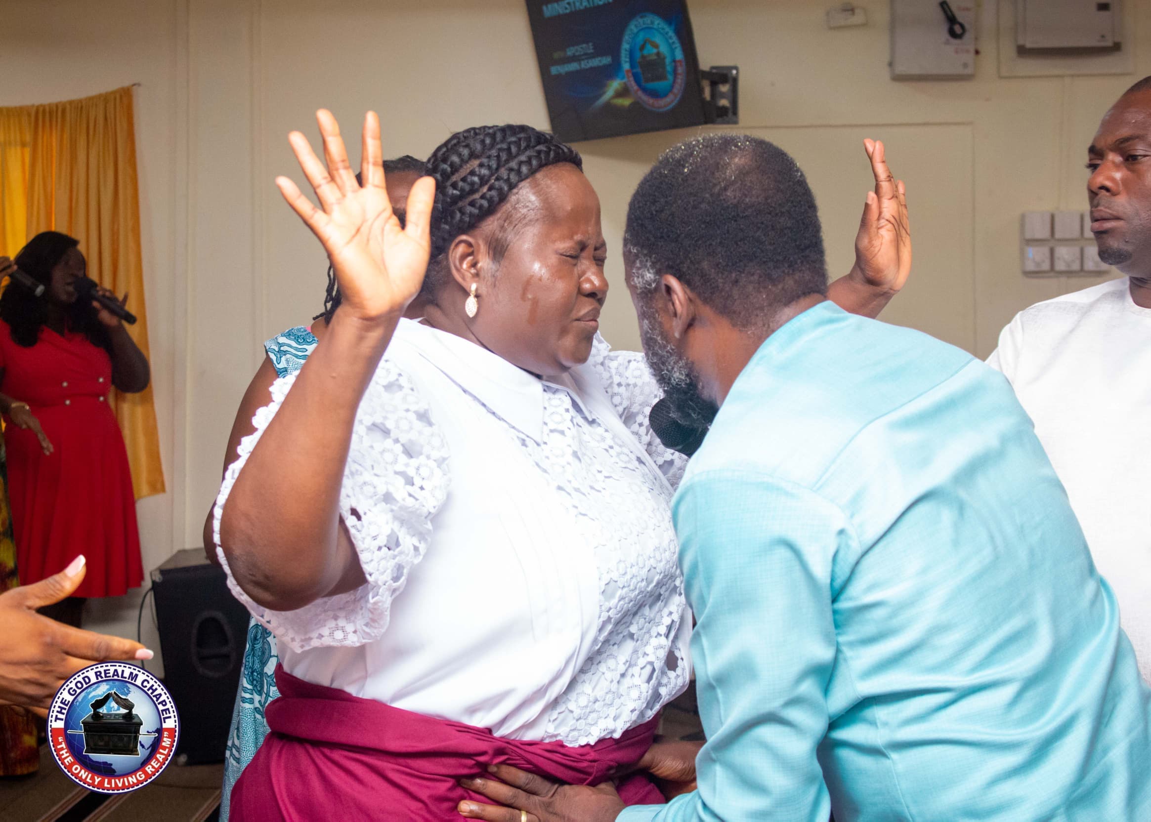 Pastor ministering to a member during worship