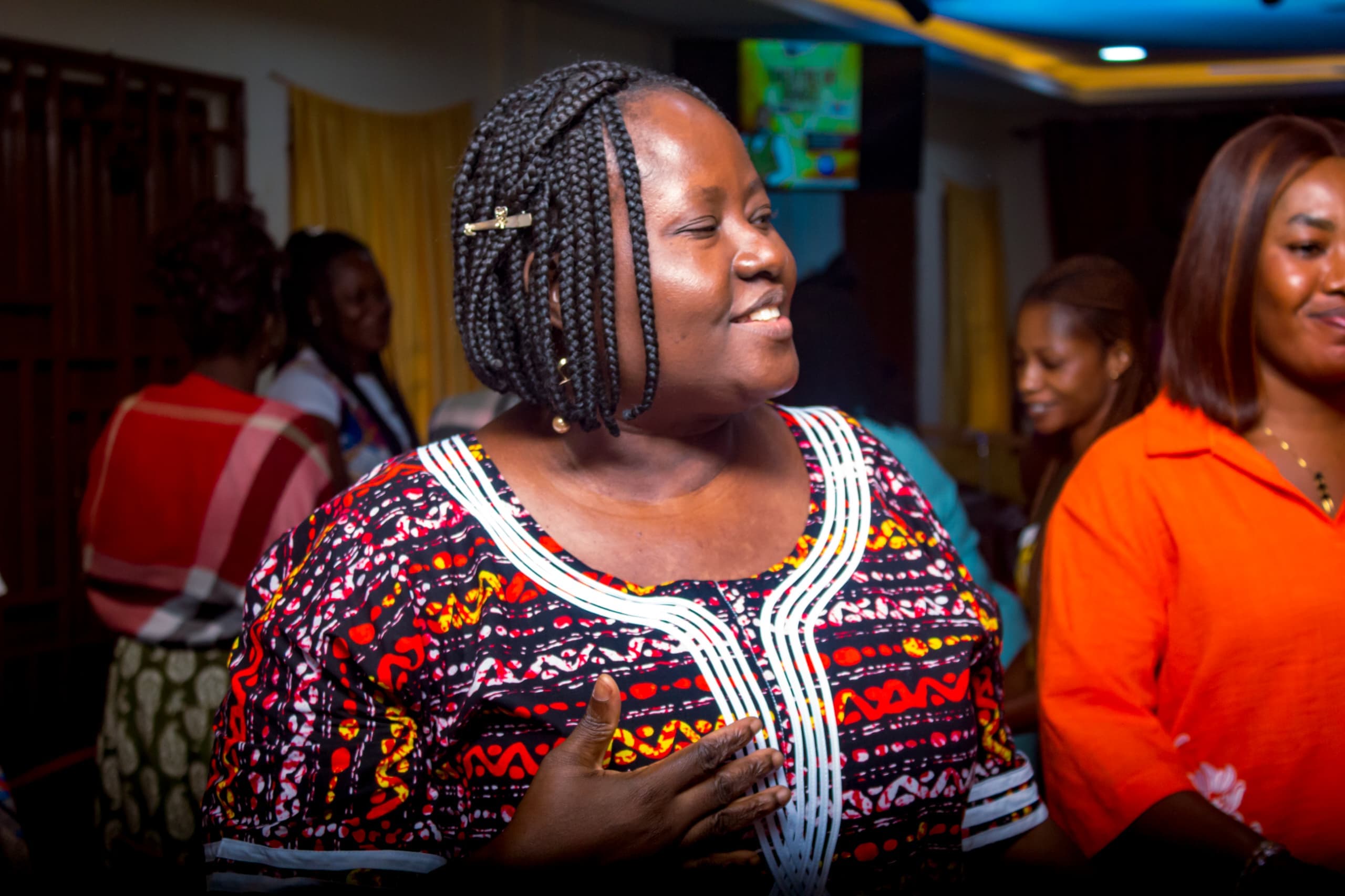 Smiling woman in African print at The God Realm Chapel