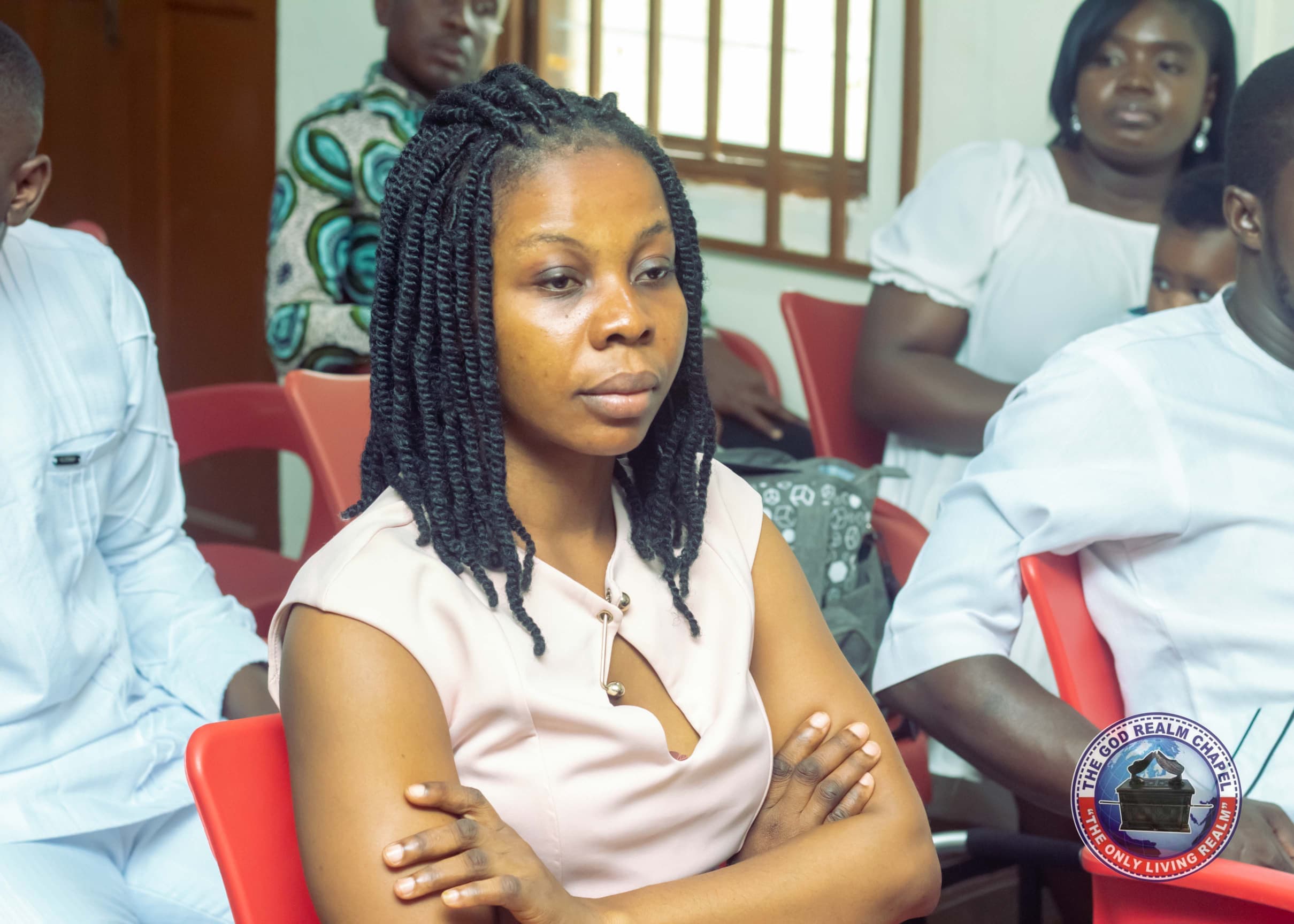 Young woman seated attentively during a church service