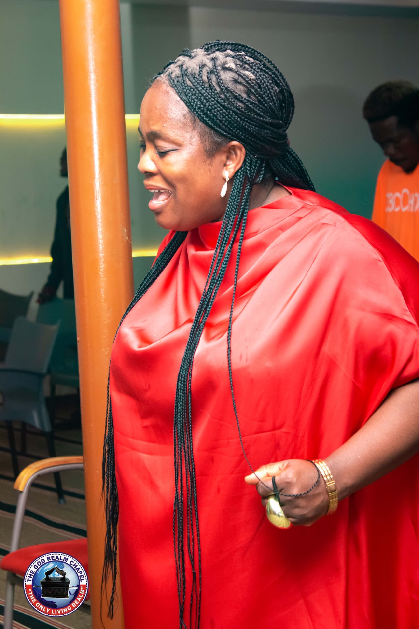 Woman singing in worship at The God Realm Chapel