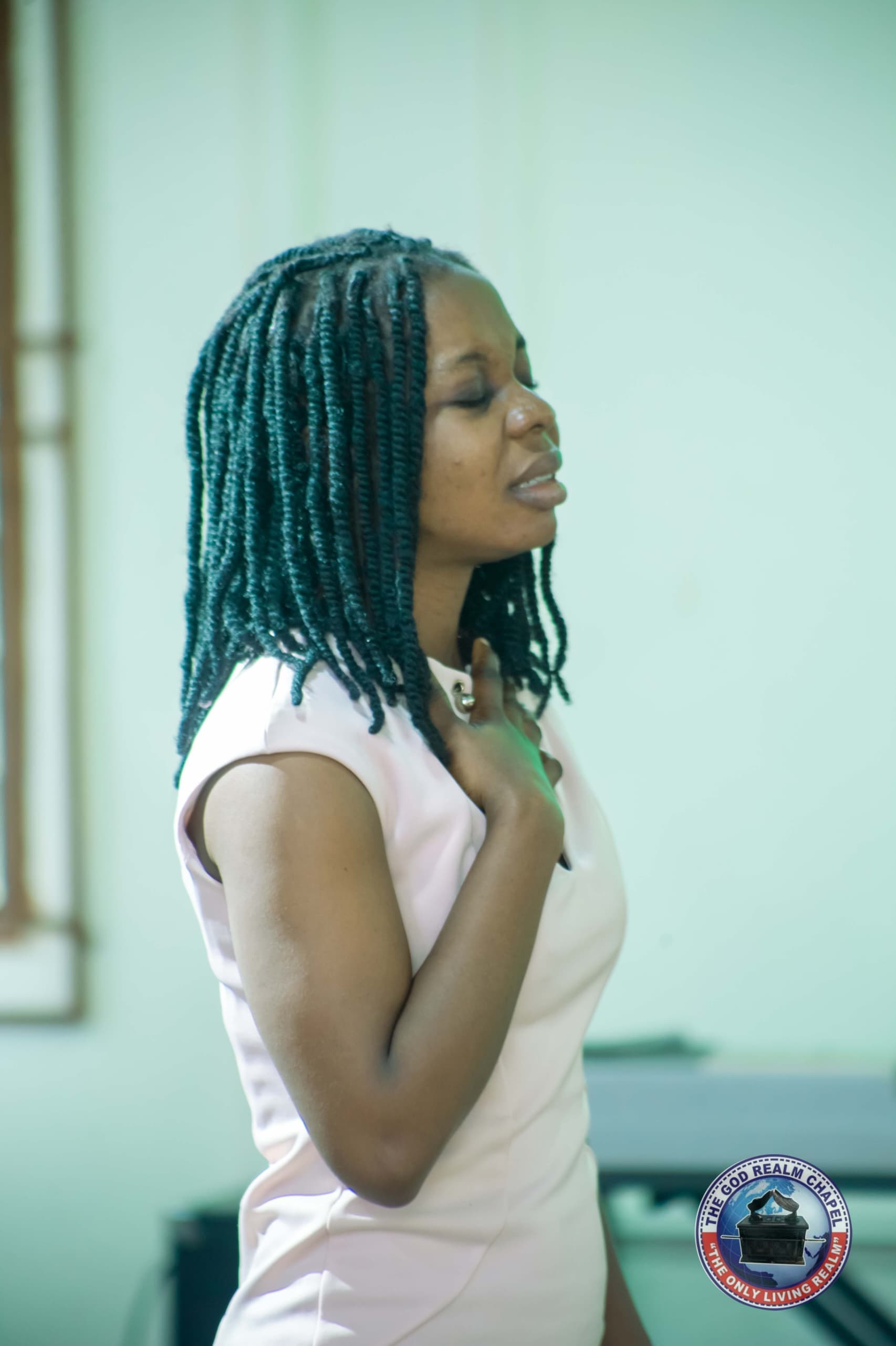 Young woman in prayer during a church service