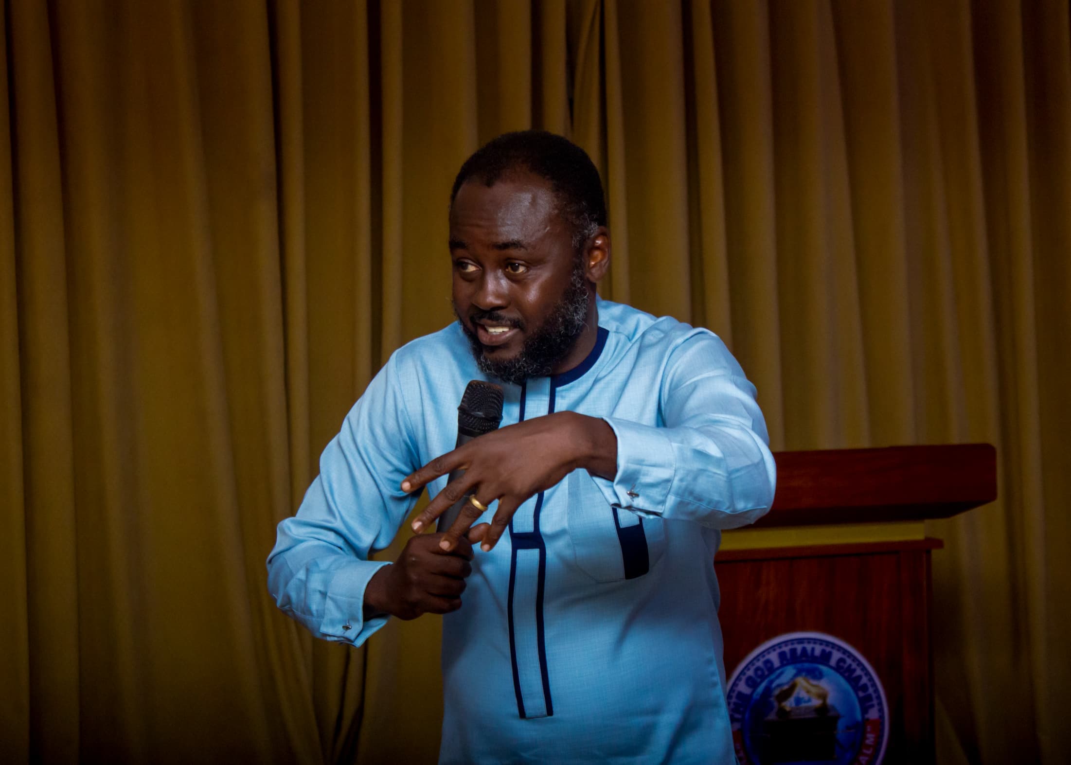Apostle Benjamin Asamoah speaking from the God Realm Chapel podium