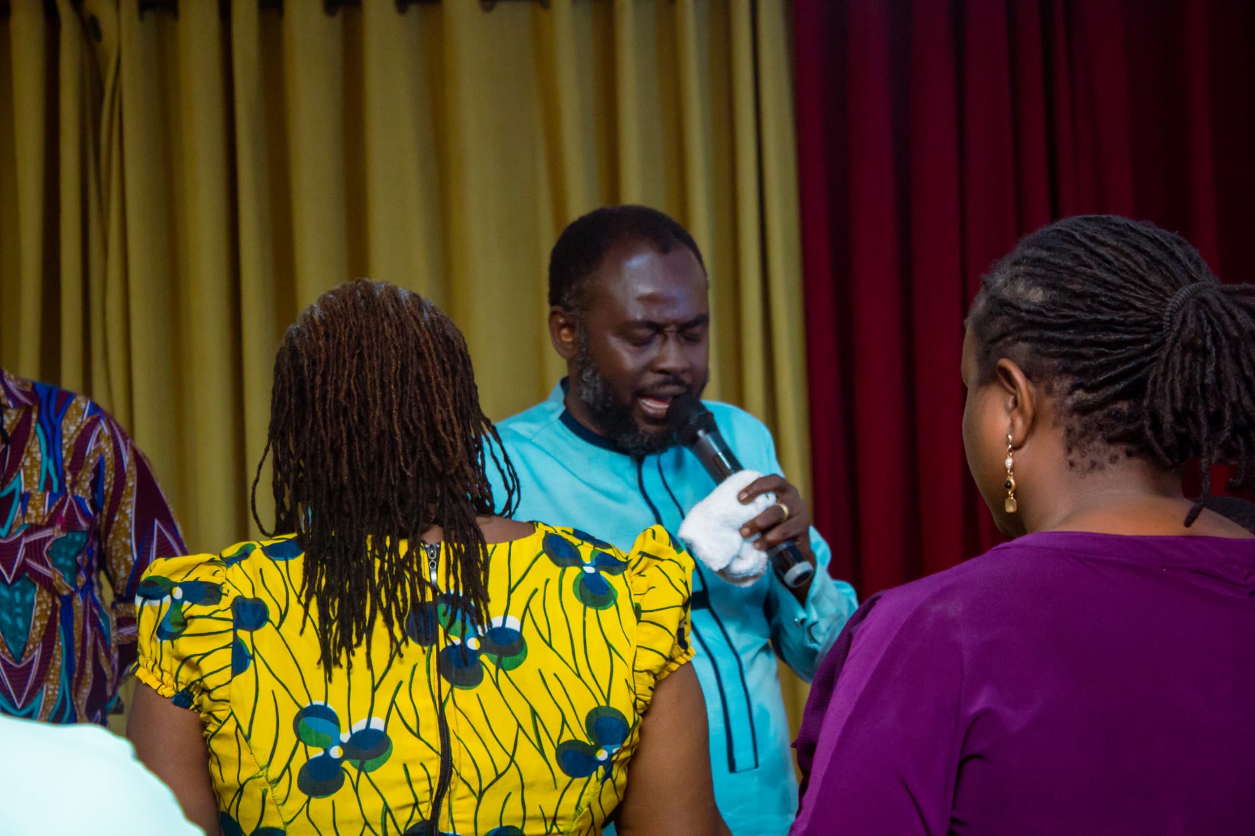 Apostle Benjamin Asamoah speaking among the congregation