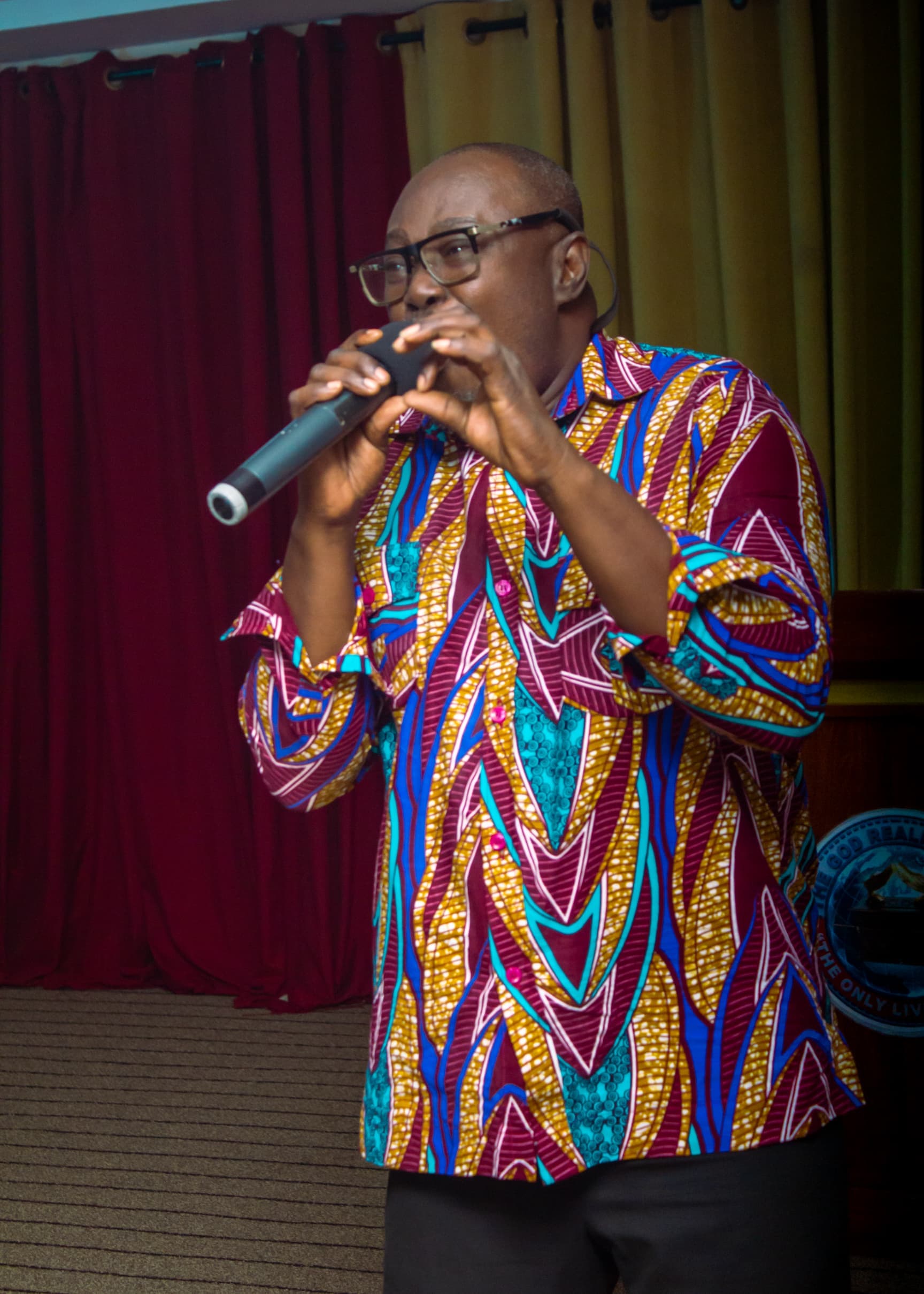 Guest speaker at the podium in Ankara print attire