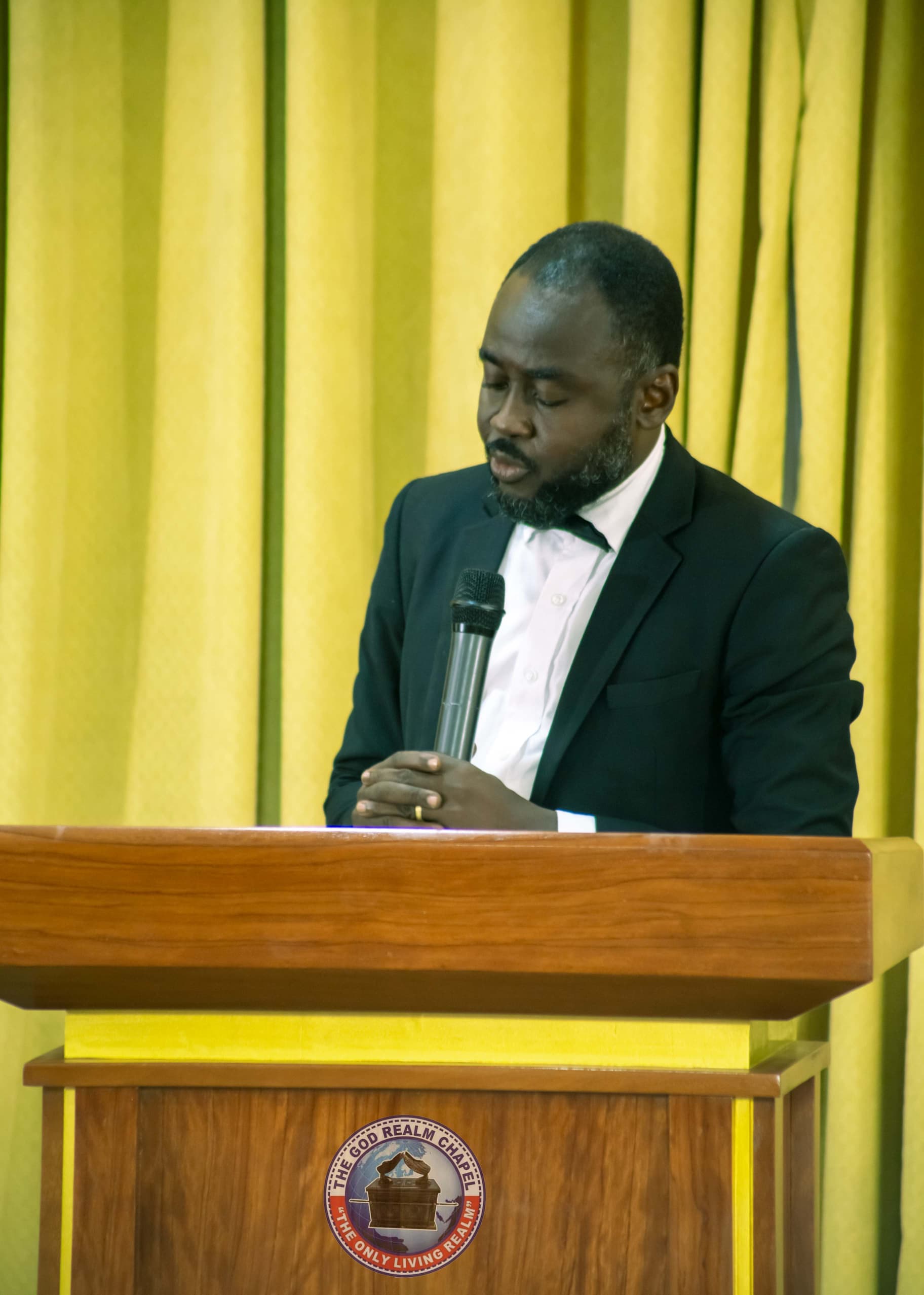 Apostle Benjamin Asamoah in prayer at the pulpit