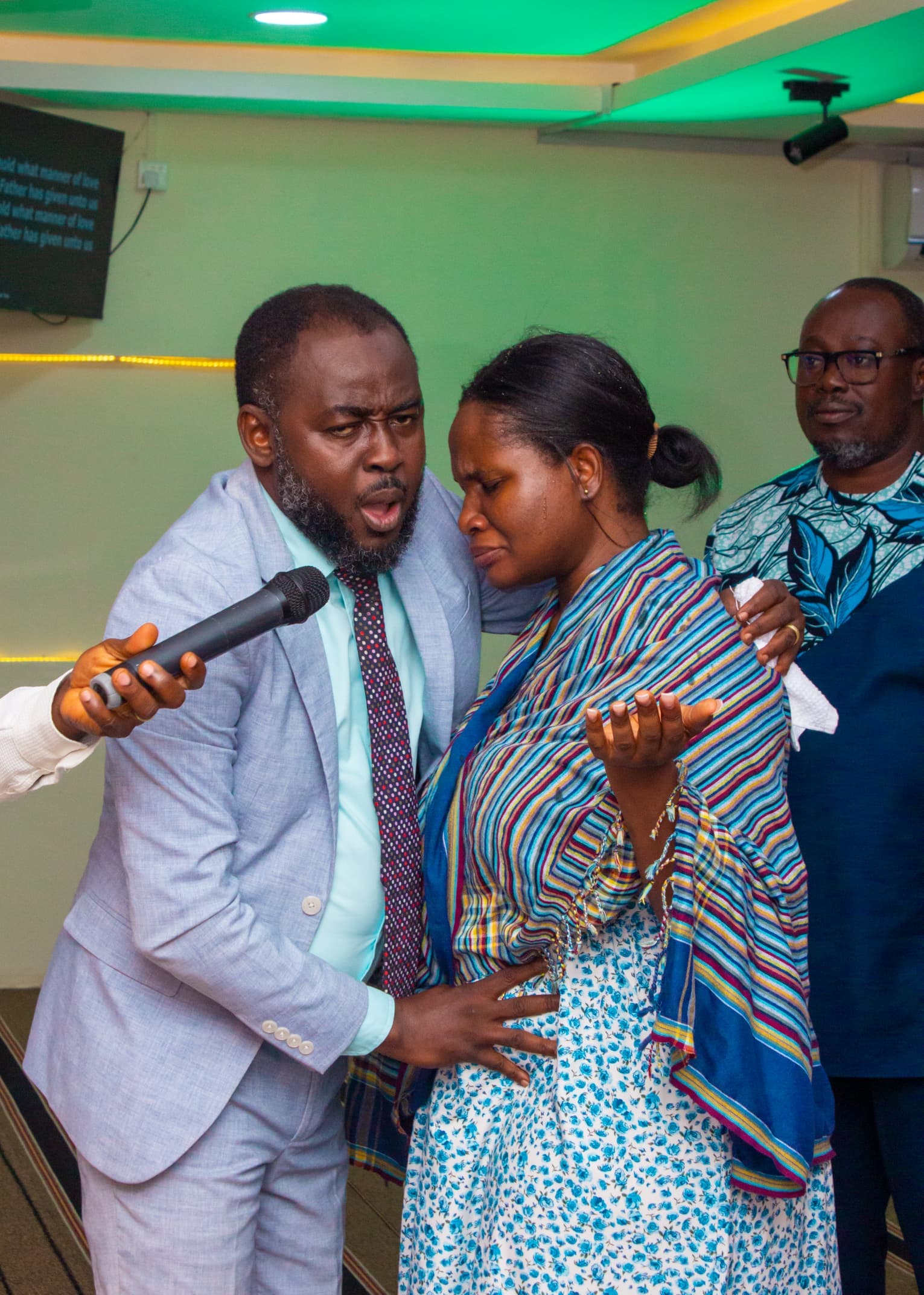 Pastor ministering to a woman during a service
