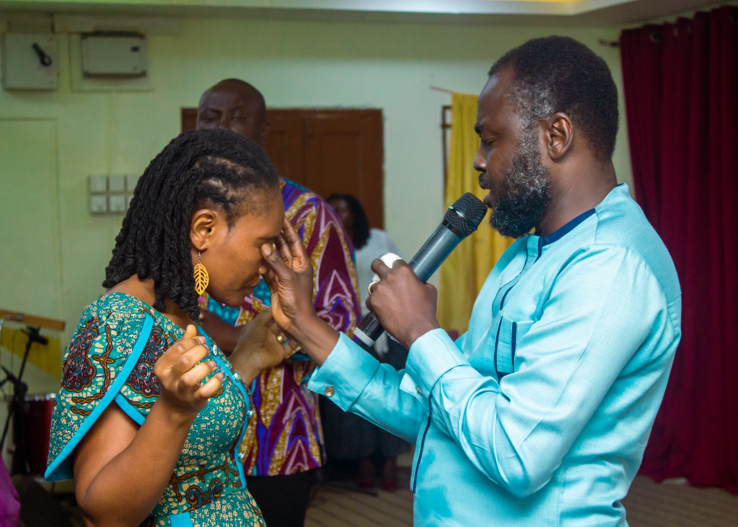 Apostle Benjamin Asamoah praying for a woman during ministration