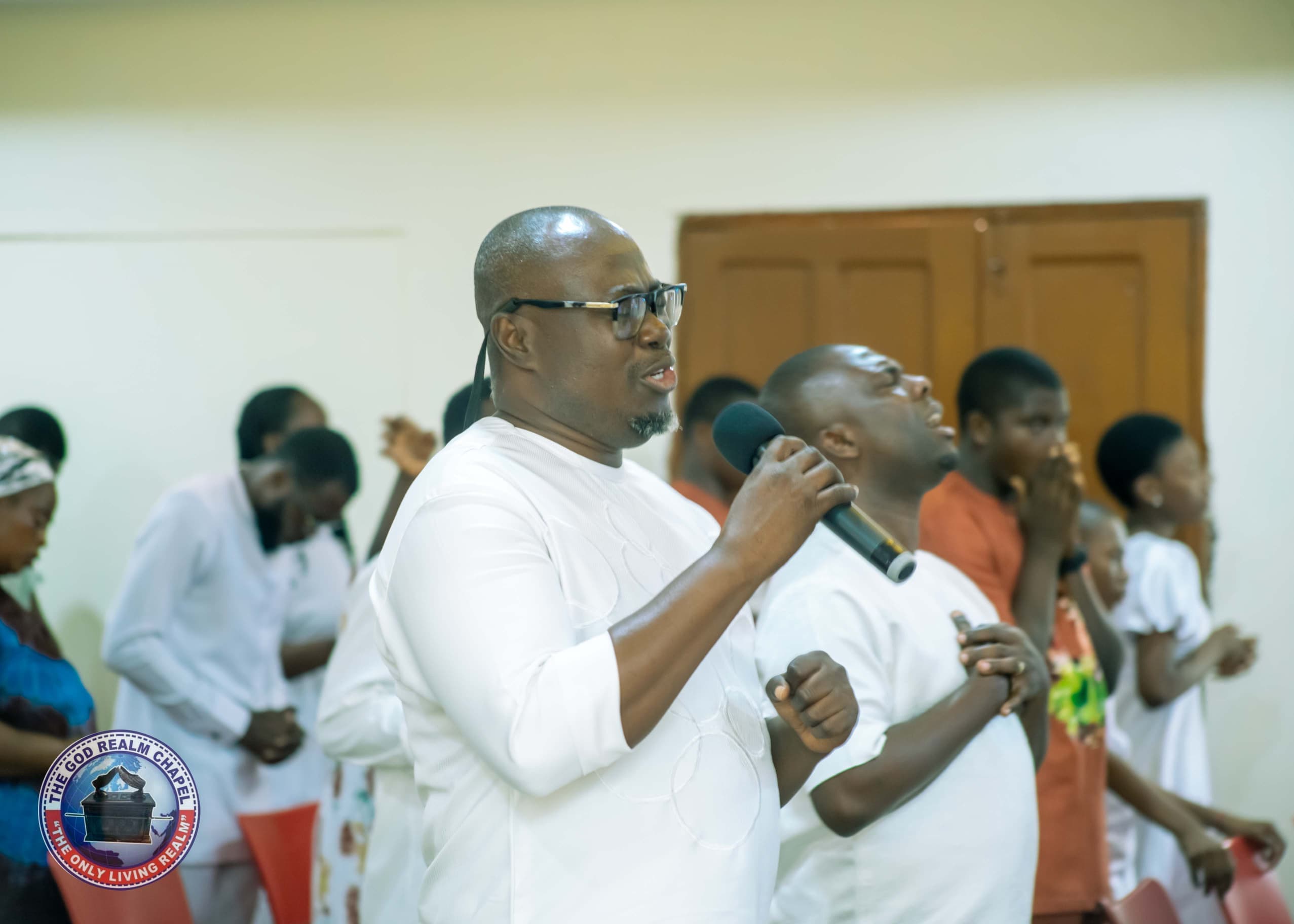 Church leader leading worship with a microphone