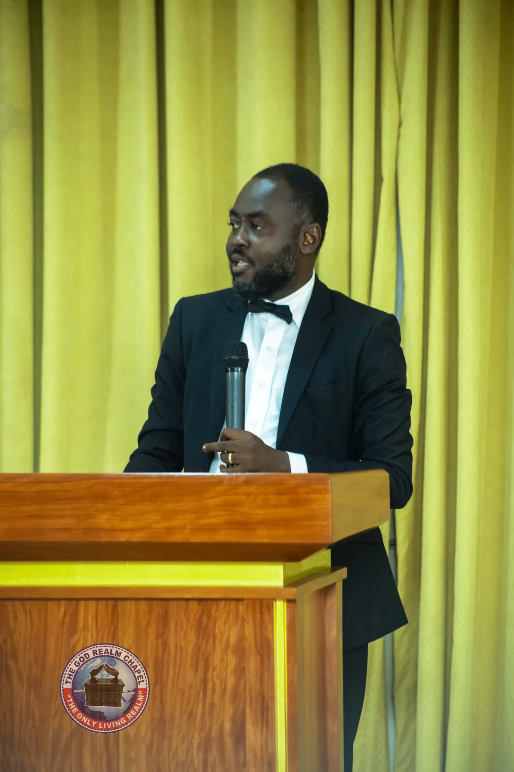 Apostle Benjamin Asamoah delivering a message at the podium